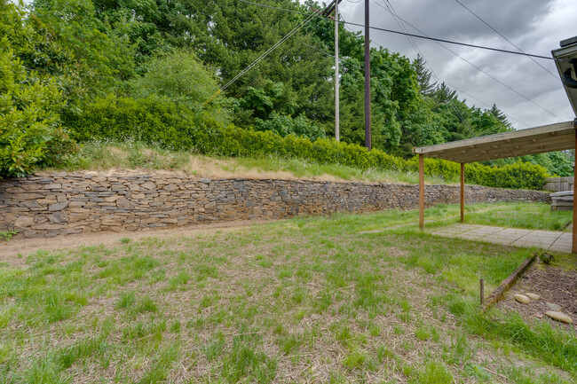 Lawn has been newly seeded and is surrounded by mature trees - 211 Farview Drive