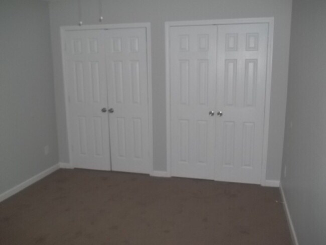 Building Photo - Freshly painted and new flooring in this 4 Bedroom 2 and Half Bath home. Covered front porch with...