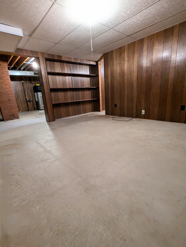 Basement photo 3 with shelving unit. - 910 Maple St