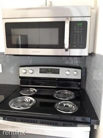 Kitchen stove and microwave - 186 NW 4th Ave