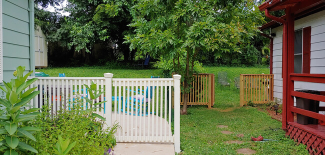 Fence to the backyard. Fence on side porch matches for a fully enclosed backyard - 819 Page St