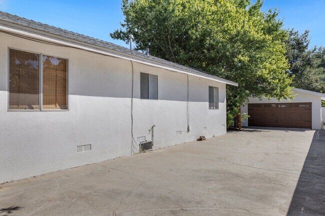 Left side yard has 2.5 car finished garage, long driveway can fit rv. - 228 N Pueblo Ave