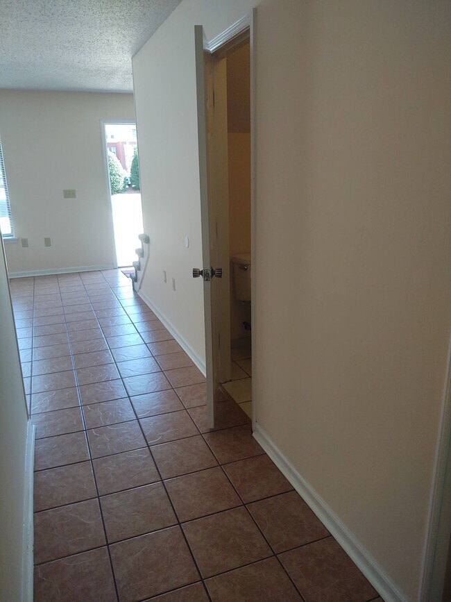 View to front entrance & powder room from dining room/kitchen - 251 Knight Dr