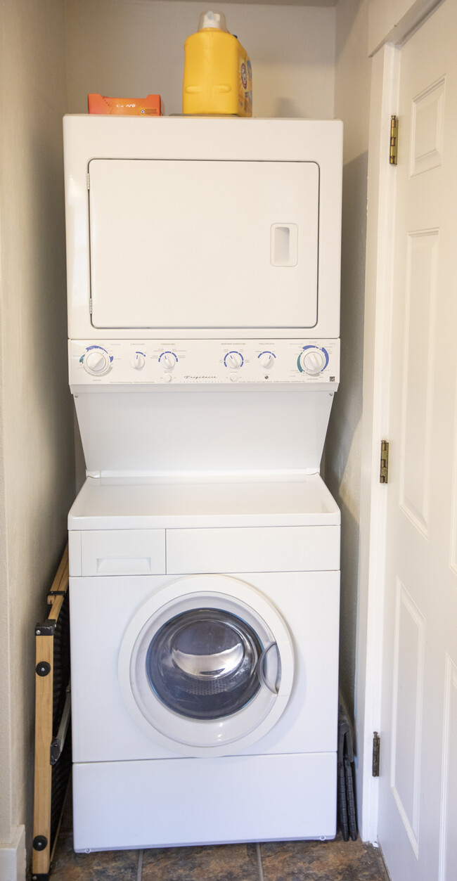 Stack Washer and Dryer. On left side we have a baby gate on right side a small step stool for use. - 717 E Lakeside Ave