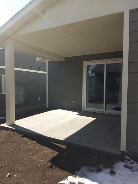 Covered back patio. This is an older picture. There is grass and a privacy fence now. - 712 N 12th St