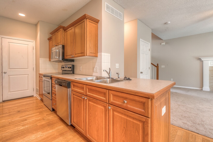 kitchen sink over looks the living room - 22810 West 71st Terrace