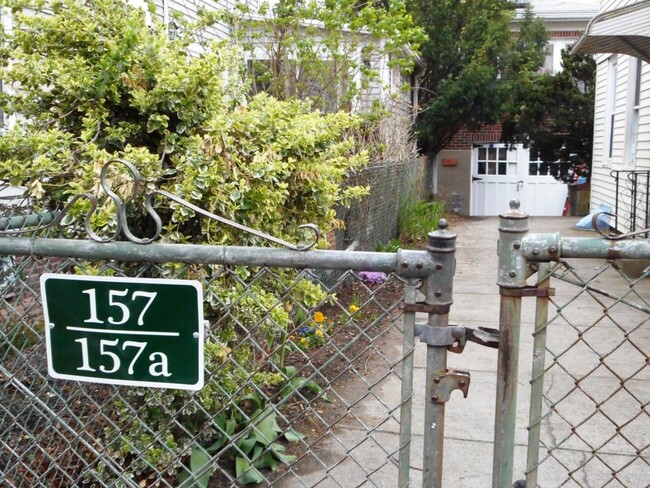 front gate, apartment entrance on left behind shrub - 157 Hamilton St