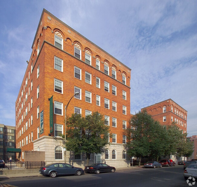 Museum Park apartment community exterior featuring historic brick architecture and urban living - Museum Park Senior 55+