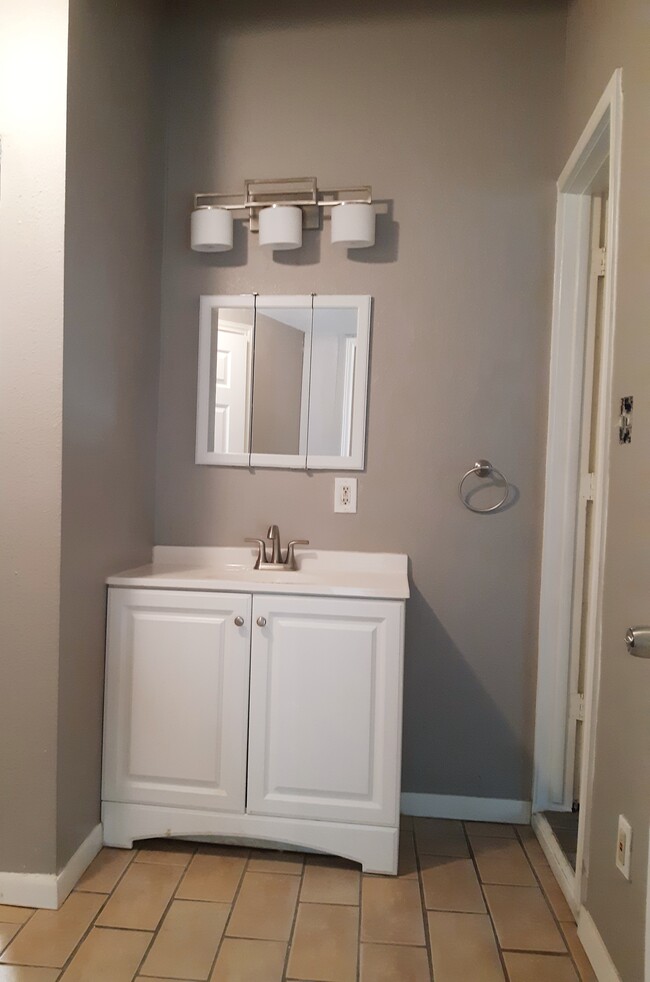 Bathroom has new medicine cabinet, light fixtures, showerhead, exhaust fan - 130 Glenwood Ct