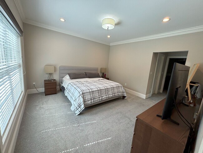Main floor, main bedroom suite with walk in closet and full bathroom attached. Carpet flooring. - 140 Wells View Rd