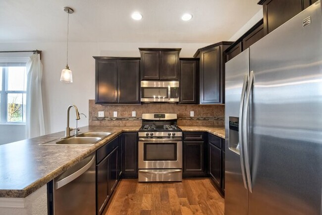 Building Photo - Immaculate 3-Bedroom Townhome with Stainless Steel Appliances and Attached Garage Near Peterson SFB