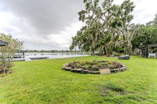 Building Photo - Lake Jessamine Luxury: Solar-Powered Waterfront Retreat on 1.14 Acres with Dock & Boathouse