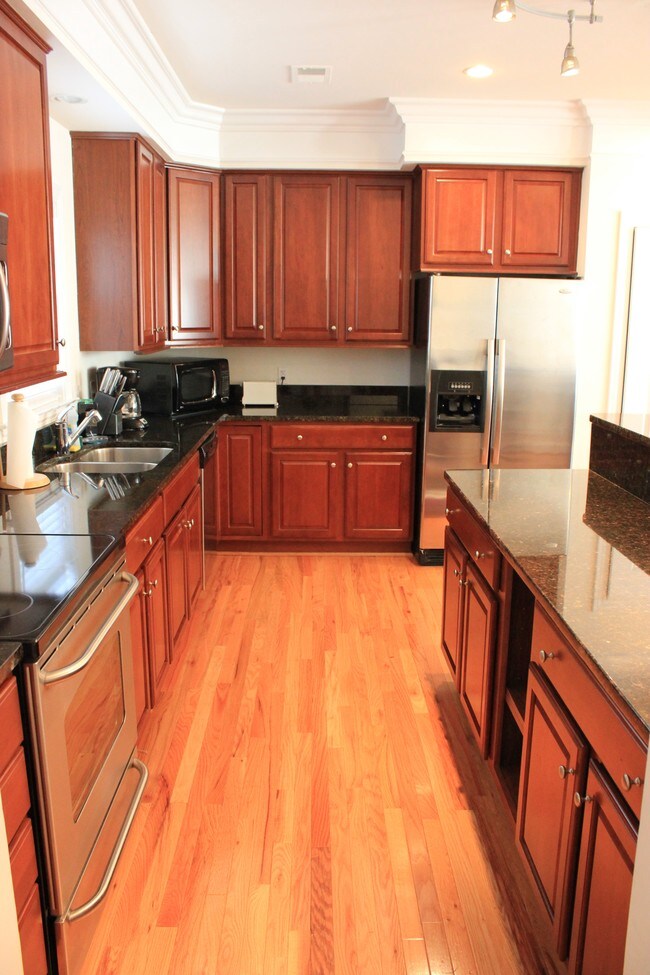 Kitchen with large island - 2418 Madeline Meadow Dr