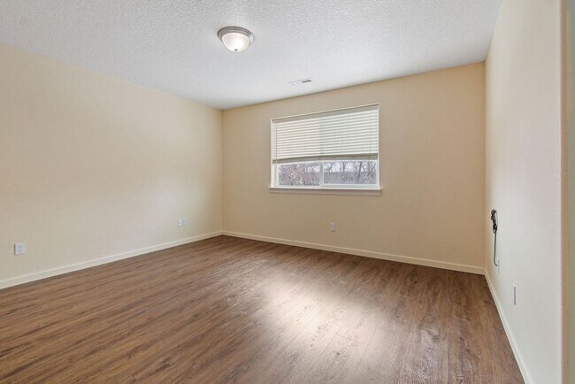 Building Photo - SPACIOUS LAYOUT! HARD SURFACE FLOORING, FENCED YARD & LARGE PATIO!