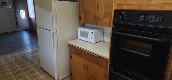 Building Photo - This is a spacious house featuring four bedrooms and two bathrooms, along with a two-car garage.