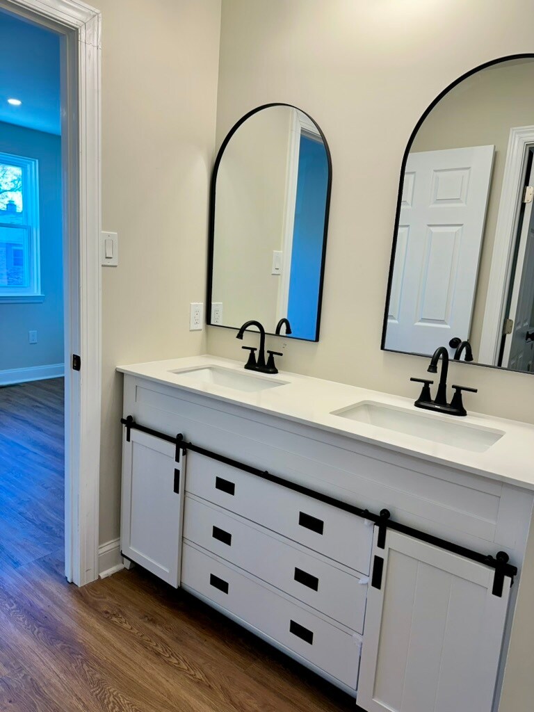 Stunning modern farmhouse bathroom with double sinks, individual mirrors, and abundant storage - 55 Providence Ave