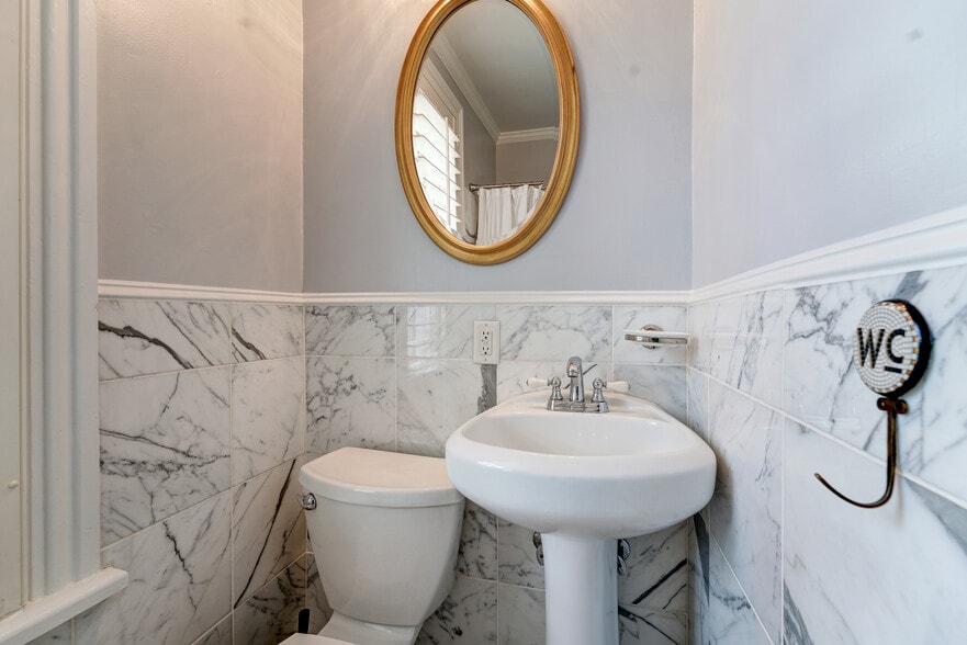 Hall Full Bathroom with marble walls & floors - 1237 29th St NW