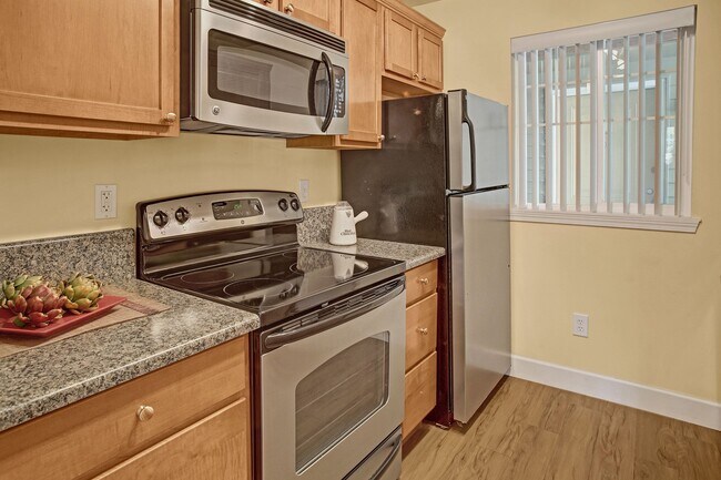 Kitchen with stainless steel oven, stove, refrigerator and microwave - Regency Woods