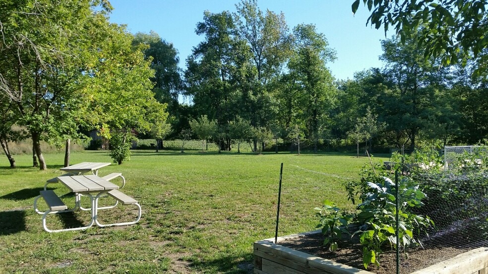 Raised garden beds available plus picnic tables - 208 W Broadway St
