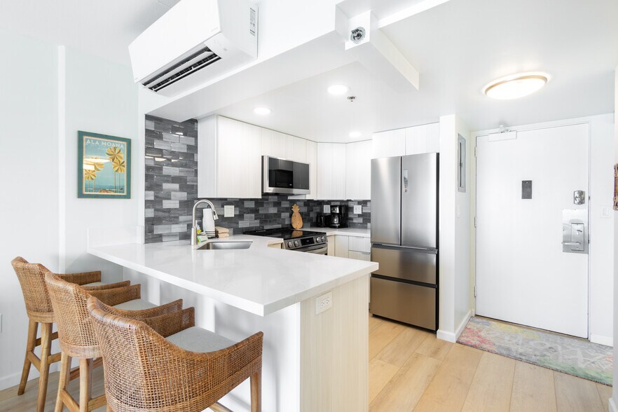 Cozy up to the bar in this chic, thoughtfully designed open kitchen - 1777 Ala Moana Blvd