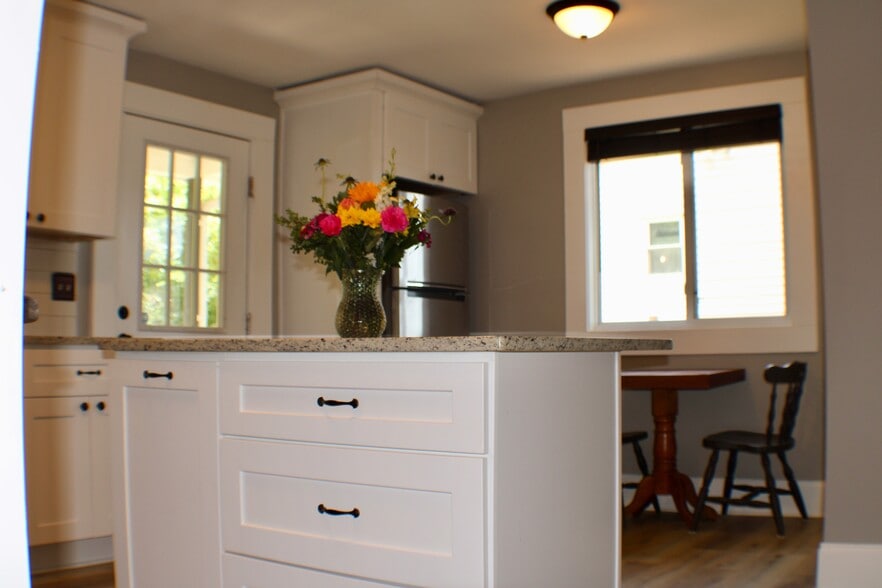 Island in the kitchen that accommodates bar stool seating - 311 Paris Mountain Ave