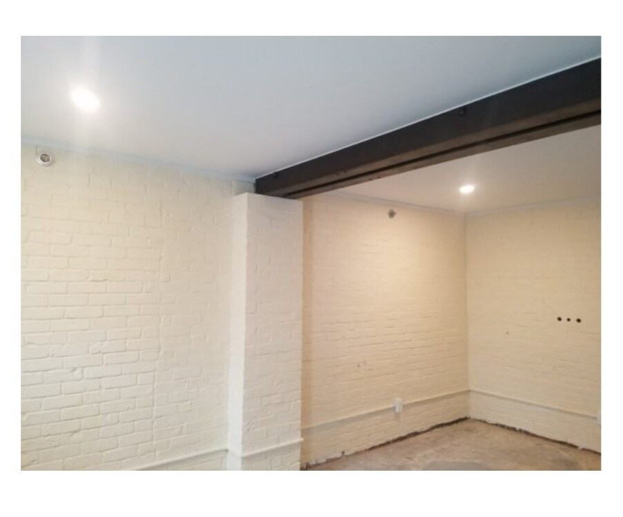 Brick and exposed beams in living room - 2362 Main St