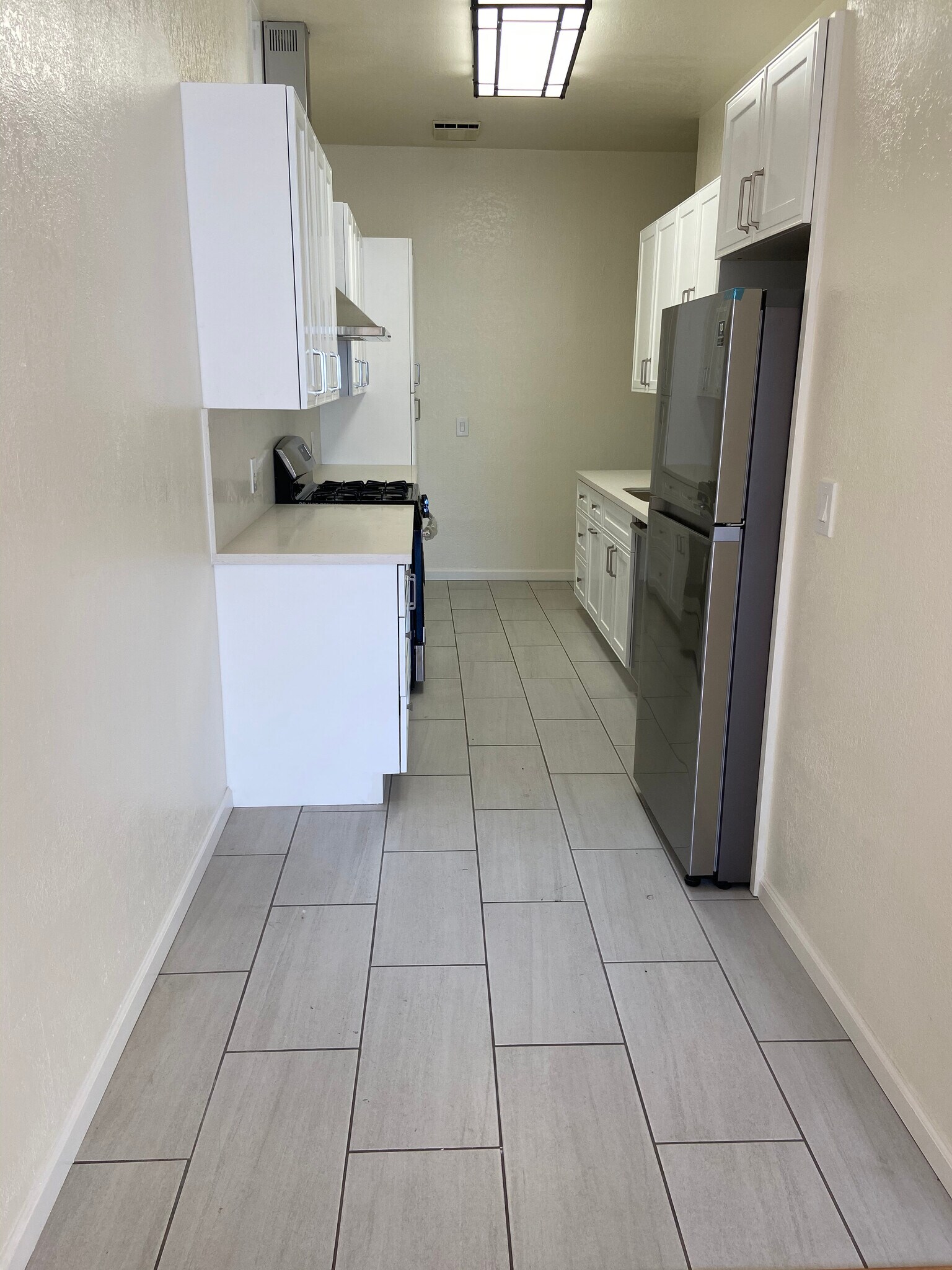 Brand new chef's kitchen with stainless steel appliances and ample cabinet space - 4179 Shafter Ave