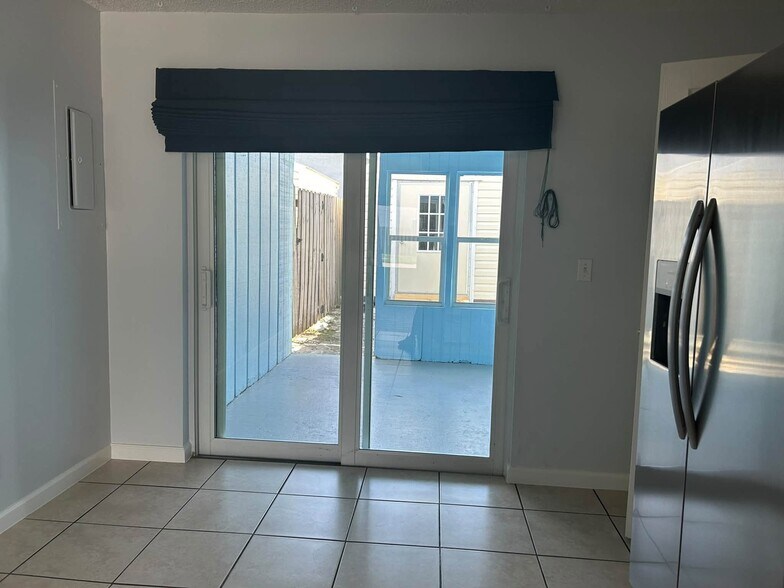 Beautiful sliders provide access to covered back porch - 7669 SE James St