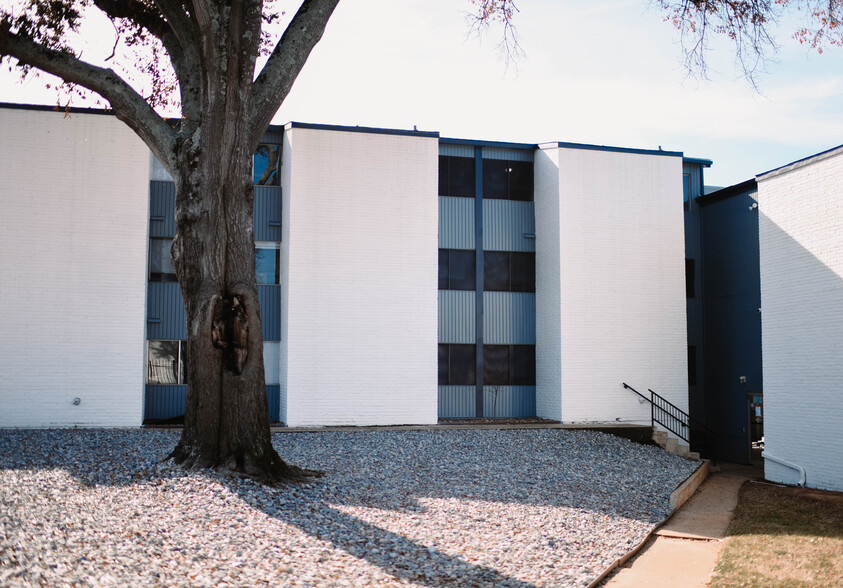 Updated White-Painted Exteriors - Uptown Apartments