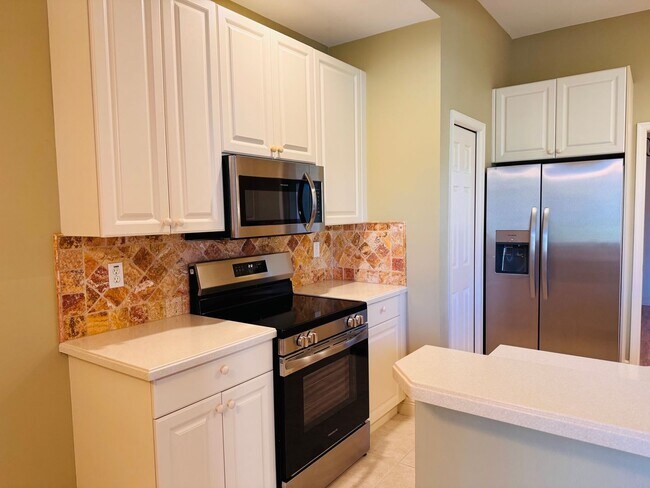 Building Photo - Experience Bell Tower Park. GATED ground floor 2 Bed 2 Bath Den 1 Car Garage Condo.