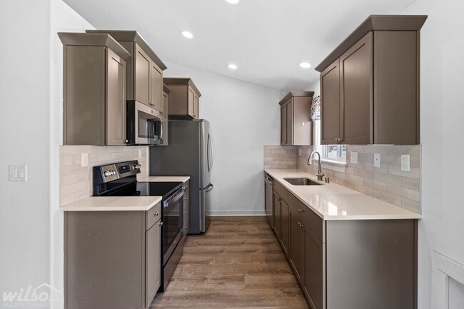 Building Photo - Welcome Home: Big Yard, Garage, and Pets A...