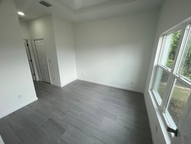 Building Photo - Brand-New 4BR/2BA Luxury Home with 2-Car Garage – Desirable 33971 Location