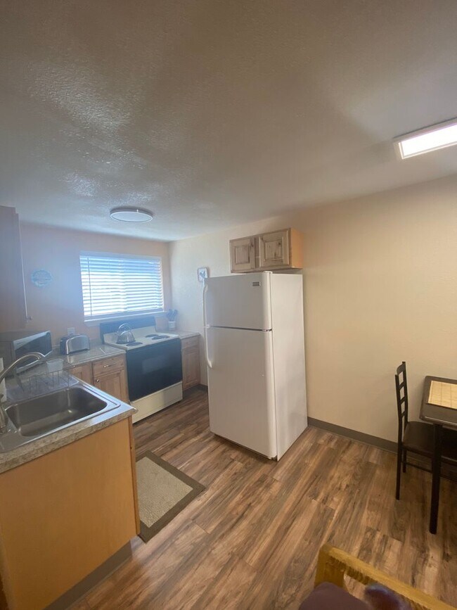 Building Photo - Adorable studio with large garage and work...