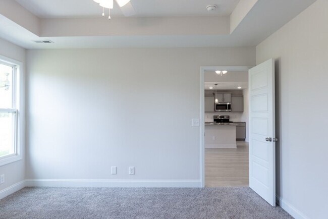 Building Photo - Modern Living Redefined with Stone Fireplace, Gray Cabinetry, Spa Inspired Primary Suite and Cove...