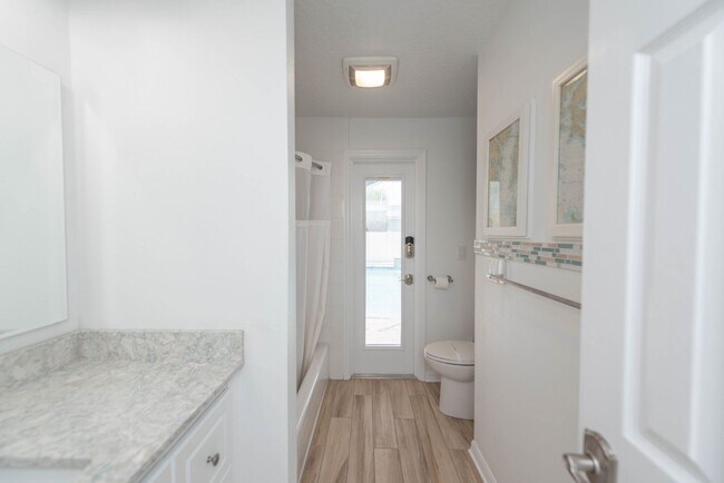 Building Photo - Live the ultimate Space Coast waterfront lifestyle at this stunning beachside canal home in Satel...