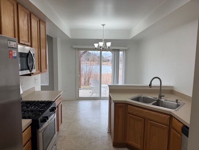 Building Photo - Partially Furnished - Bright & Spacious 2BR/1.5 BA CONDO - End-Unit w/ 2-Car Garage, Appliances, ...