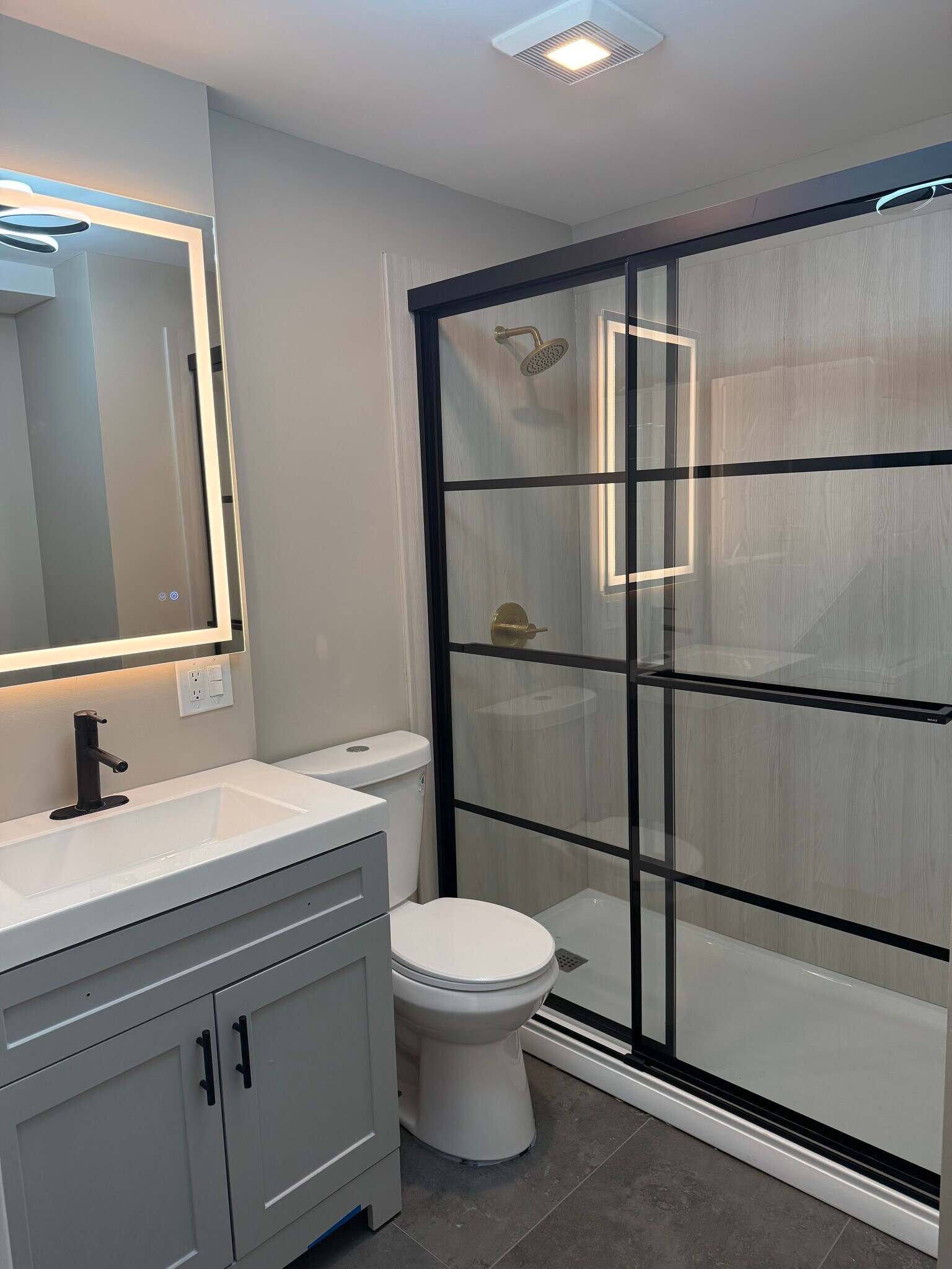 Walk in shower with black and gold finishes - 1628 W Cermak Rd