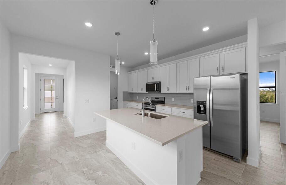 Island Kitchen with tile backsplash - 18928 Indian Rock Pl