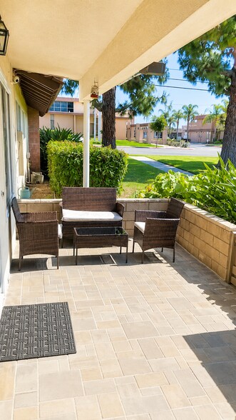 Private front patio with seating area, greenery, and a quiet outdoor space to relax. - 339 E Taft Ave