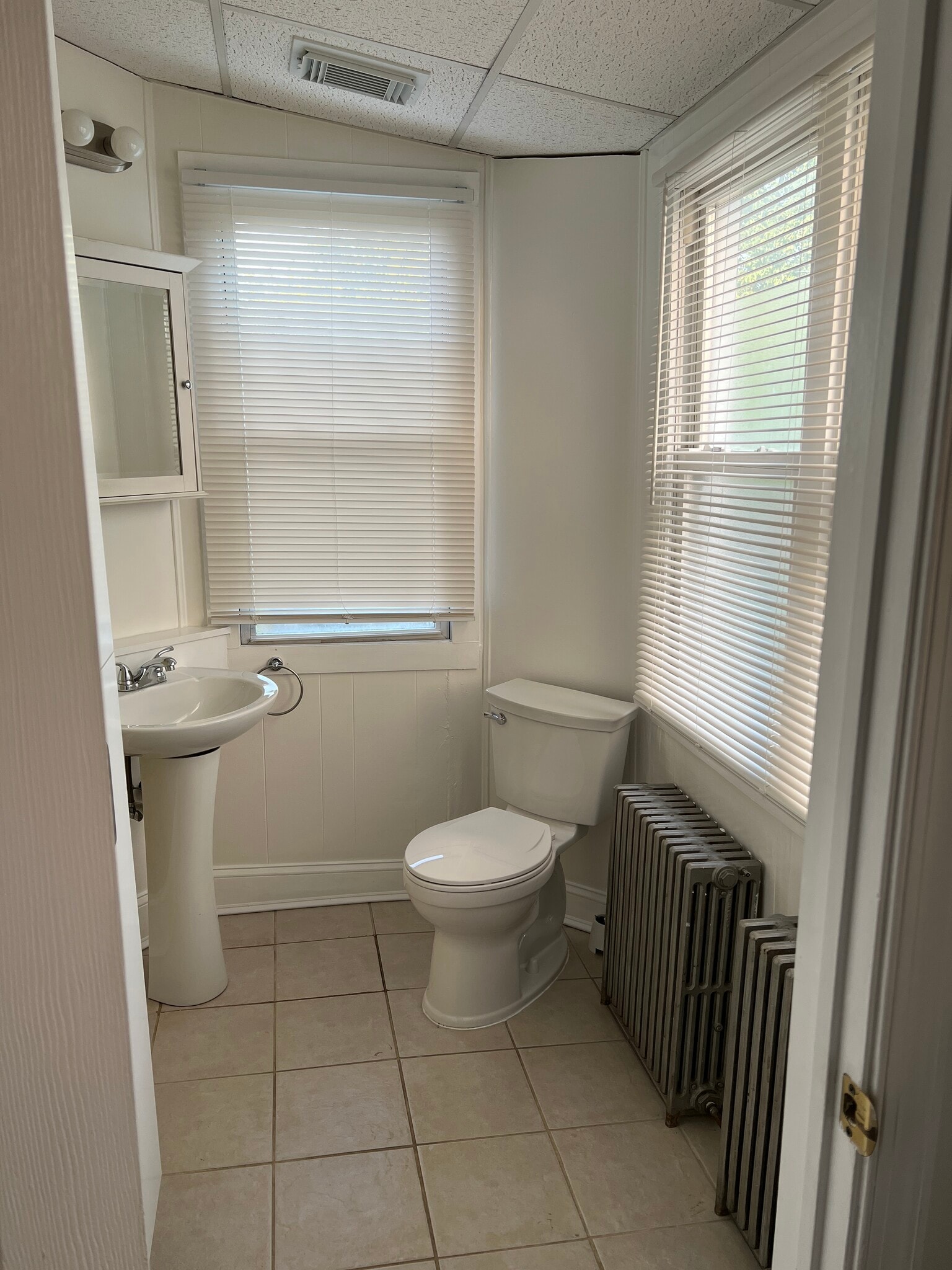 The spacious half bathroom features a large storage cabinet. - 126 Merion Ave