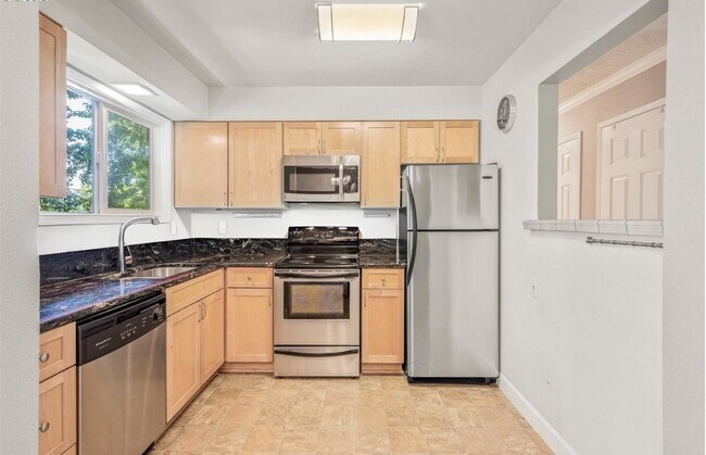 Building Photo - Spacious 2-Bedroom Condo with Forest Views, Private Balcony, In-Unit Laundry & Community Amenitie...