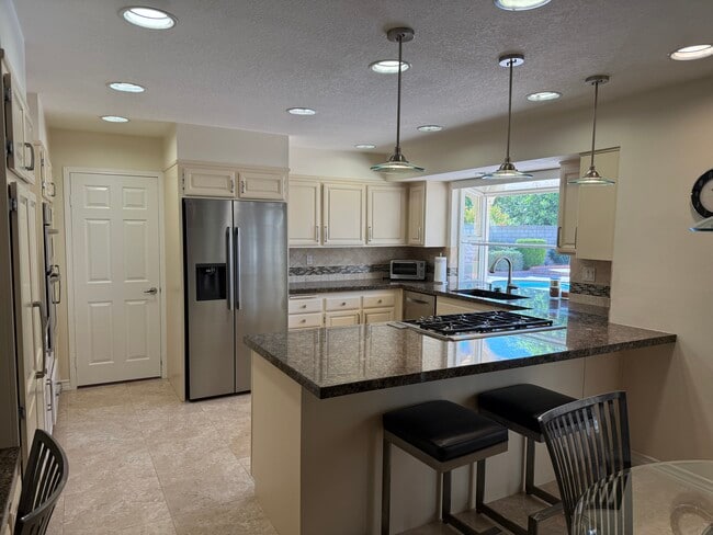 Kitchen with Bar Stools - 23446 Blythe St