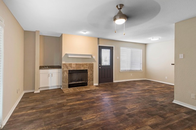 Living Room with Hardwood Style Flooring - Lake Village West Apartments