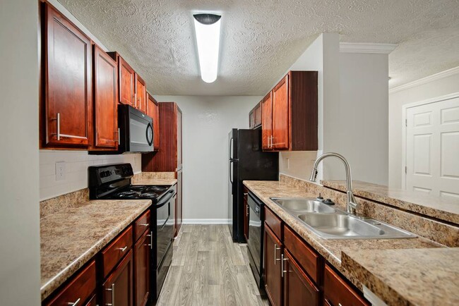 Cherry Wood Upgrade: Cherrywood cabinets, black appliances, updated lighting - Crestmark Apartment Homes