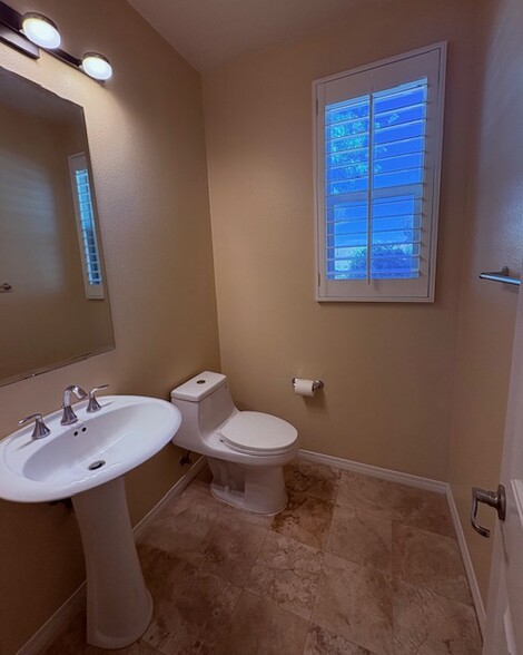Half bathroom conveniently located downstairs. Travertine floor and modern lighting - 26019 Brinton Plz