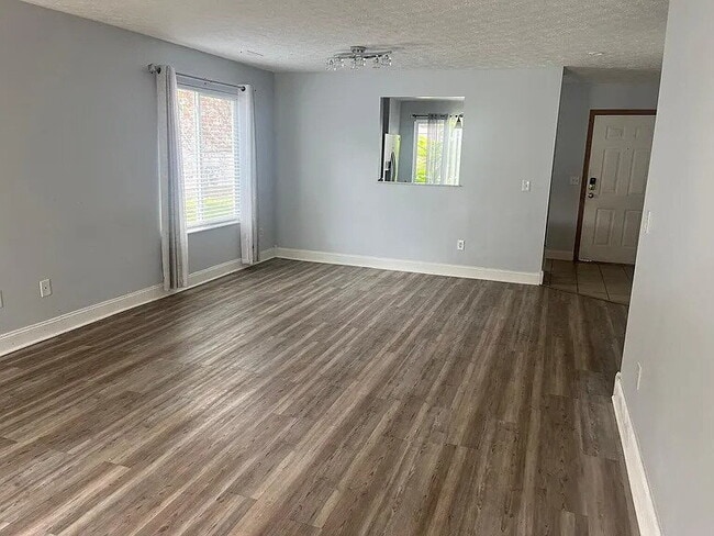 Building Photo - The home features beautiful LVP flooring, granite countertops, stainless steel appliances, and a ...