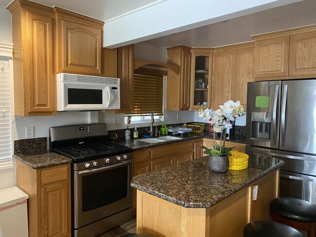 Kitchen with all cooking utensils and pots and pans - 10725 Westminster Ave