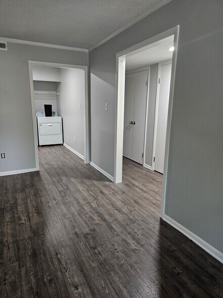 A long hallway splits off from the living area keeps both bedrooms private. - 8582 Chesapeake Blvd