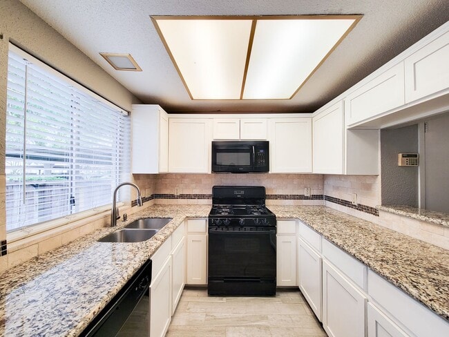 Building Photo - Welcome to This Charming Townhome Nestled ...