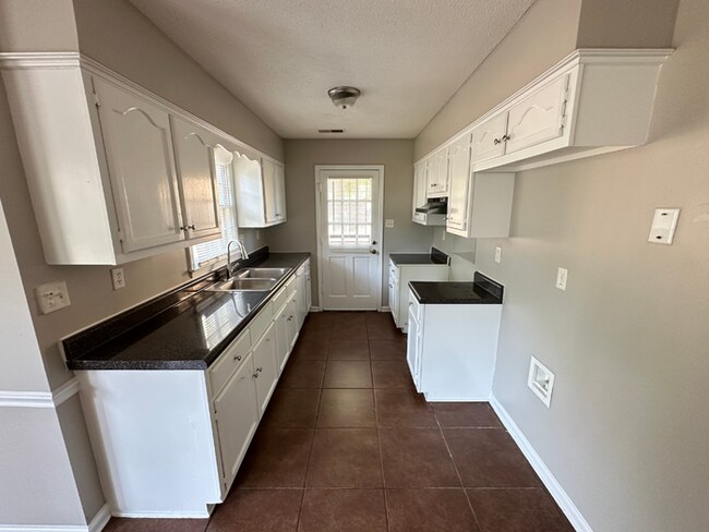 Building Photo - Charming 3BR/2BA Near Southwind | Hardwood Floors, Brick Fireplace, Bay Window & 2-Car Garage